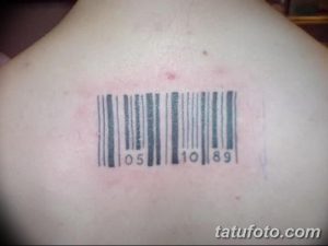 Фотография татуировки штрих-кода с цифрами '105 10 89' на плече. Черный рисунок татуировки четко выделяется на светлой коже.