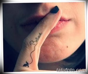Фото тату надписи 'Believe' и маленькой бабочки на женском пальце. Нежный и минималистичный рисунок татуировки.