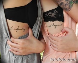 Фотография двух девушек с парными татуировками на груди, с надписями 'To infinity' и 'and beyond'. Идеально для выражения любви и дружбы.