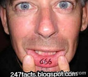 Фото татуировки с изображением цифр 666 на внутренней стороне губы. Стиль татуировки - минимализм, чёрный цвет.