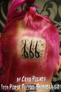 Фото тату с изображением цифр 666 на затылке, выполненное в черном цвете с элементами красных брызг. Стиль татуировки - графика.