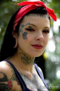 Фото тату на лице и шее девушки: надписи, рисунки, красная повязка на голове, пирсинг. Идеи для тату в стиле гранж.