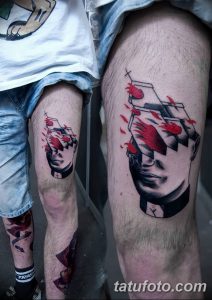 Фото тату на бедре: сюрреалистичная татуировка, изображающая лицо, заключенное в разбитый куб с красными брызгами. Необычный и запоминающийся рисунок.
