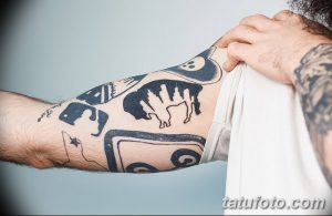 Фото тату бизона в стиле олдскул, с использованием черных контуров и минимального количества цветов. Татуировка расположена на руке среди других татуировок.