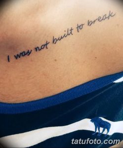 Фотография татуировки на боку с надписью 'I was not built to break', выполненной простым шрифтом в черном цвете.