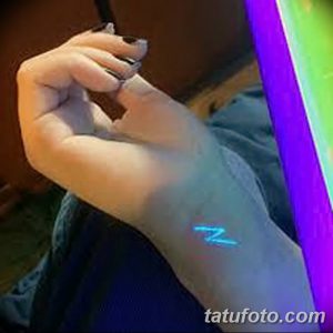 Фотография минималистичной татуировки в виде буквы Z, светящейся в ультрафиолете на запястье. Простой и лаконичный рисунок.