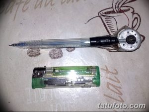 Фото самодельной тату-машинки, сделанной из ручки и зажигалки, на белом фоне. Инструменты для татуировки, сделанные своими руками.