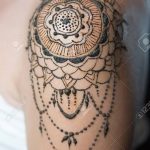 Closeup henna tattoo on woman's shoulder