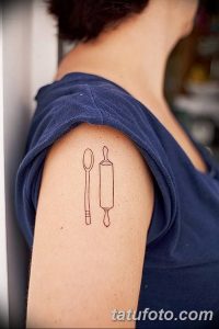 Фото тату ложки и скалки на плече. Простой линейный рисунок, выполненный черными чернилами. Оригинальный и минималистичный эскиз татуировки.