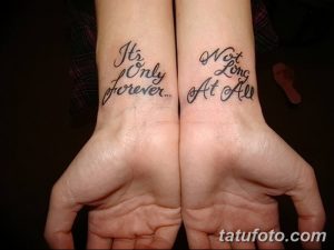 Фото тату на запястьях двух людей с надписями 'It's Only forever...' и 'Not Long At All'. Черно-белые татуировки, выполненные каллиграфическим шрифтом.