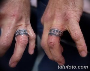 Фото тату: парные татуировки в виде колец с надписями на пальцах, выполненные в сером цвете.