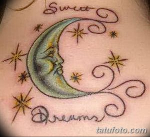 Татуировка на коже с изображением луны, звезд и надписи "Sweet Dreams". Нежные цвета и романтичный стиль.