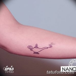 Фото минималистичной татуировки лампы Аладдина. Тонкие линии, простой рисунок татуировки, расположен на руке.