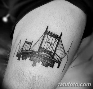 Фото минималистичной татуировки моста на руке, выполненной в технике blackwork с использованием только черного цвета и четких линий.