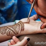 Painting Henna Paste On Woman's Hand
