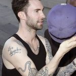 Singer Adam Levine, a coach on "The Voice" bares his arms and his many tattoos outside the "Jimmy Kimmel Live" studios in Los Angeles