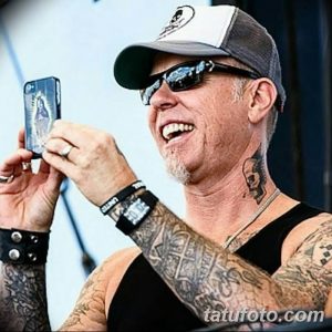 Фотография Джеймса Хетфилда, делающего селфи на телефон, с видимыми татуировками на руках и шее.