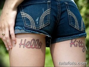 Фото татуировок на бедрах, изображающих надписи "Hello Kitty" в розовом цвете. Стиль - мультяшный, яркий и игривый.