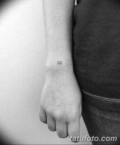 Фото тату маленькой волны на запястье. Черно-белый рисунок татуировки выполнен в минималистичном стиле.