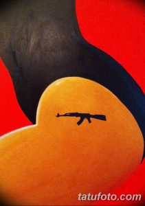 Фото татуировки, изображающей автомат Калашникова на фоне сердца. Черно-белый рисунок с использованием ярких цветовых акцентов.
