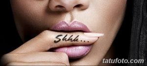 Фото тату на пальце: надпись "Shhh..." черными чернилами. Минималистичная татуировка, пример рисунка татуировки для девушек.
