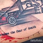 Фото тату на руке с изображением автомобиля и надписью 'a overcomes the fear of death'. Чёрно-серый рисунок в мрачном стиле.