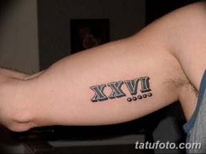 Фото тату: минималистичная татуировка с римскими цифрами XXVI на руке. Простой и стильный дизайн для тех, кто ценит лаконичность.