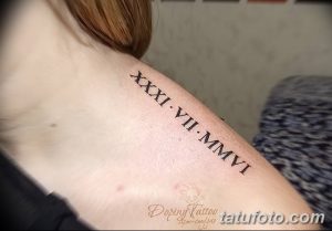 Фото тату: татуировка с римскими цифрами 'XXXI.VII.-MMVI' на плече. Черный цвет, четкие линии, классический стиль.