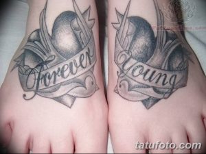 Фото парных татуировок надписи 'Forever Young' с изображением сердца на стопах.