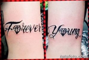 Фото тату с надписью 'Forever Young' и изображениями бриллиантов на предплечьях. Стильная татуировка, выполненная в черном цвете с добавлением блестящих элементов.