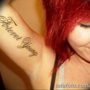 Фото тату с надписью 'Forever Young' на ключице, выполненной изящным шрифтом. Элегантный дизайн на светлой коже.