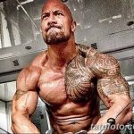 Фотография Двейна Джонсона с татуировкой на плече и груди во время тренировки в спортзале.