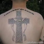 Фото татуировки кельтского креста на спине с надписью "I mo chroi go brath" и кельтским плетением. Черно-белый рисунок с четкими линиями.