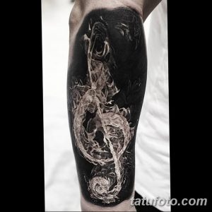 Фото тату розы, выполненной в технике blackwork на ноге. Контрастный рисунок с использованием черных чернил и негативного пространства.