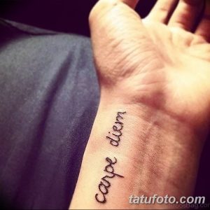 Фото тату надписи 'carpe diem' на запястье. Простая, черная надпись, выполненная тонким шрифтом, выглядит элегантно и ненавязчиво.