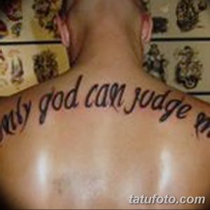 Фото тату на шее: надпись 'Only God Can Judge Me' каллиграфическим шрифтом. Черно-белая татуировка, изящный дизайн.