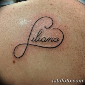 Фото тату: имя 'Liliana' написано красивым шрифтом внутри контура сердца, выполненного черными чернилами на спине. Женственная и нежная татуировка.