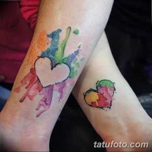 Фото акварельных тату на руках: две татуировки в виде сердец, выполненные в технике акварели с использованием ярких и пастельных цветов.