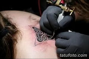 Фото тату кельтского узла на лопатке. Черный рисунок татуировки с четкими линиями и сложным переплетением, выполненный опытным мастером тату.