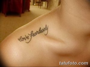 Фото тату надписи 'Love Fearlessly' черным цветом на ключице. Изящный шрифт, подчеркивающий красоту линий.