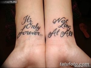 Фото парных татуировок на запястьях с романтичными надписями 'It’s Only Forever...' и 'Not Long At All', символизирующими вечную любовь.