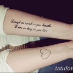 Фото татуировки с надписью 'Laugh as much as you breathe. Love as long as you live' и маленьким сердечком на руке.