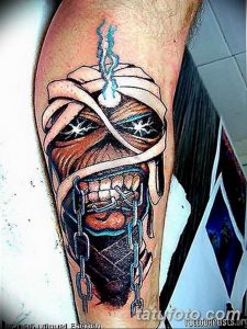 Фото татуировки на руке с изображением Эдди, талисмана группы Iron Maiden. Детализированный черно-серый рисунок с элементами киберпанка.