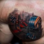 Фото тату на руке: штанга, выполненная в реалистичном 3D стиле. Детализированная проработка, яркие цвета, спортивная тематика.