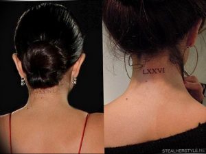 Фото тату: черные римские цифры 'LXXVI' на затылке женщины, выполненные в минималистичном стиле.