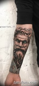 Фото тату с изображением бога Посейдона на руке. Детализированная проработка лица, бороды и волос, а также элементов морской стихии.