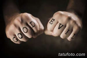 Фото тату: надписи 'GOOD' и 'EVIL' на костяшках пальцев, символизирующие борьбу добра и зла. Смелый и провокационный эскиз тату.