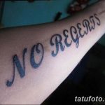 Фото тату на руке: надпись 'No Regrets' выполненная курсивным шрифтом, символизирующая свободу и отсутствие сожалений.