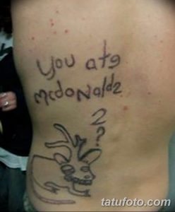 Фото тату с надписью "You ate McDonalds ?" и рисунком мультяшного персонажа на боку. Рисунок выполнен в простом, наивном стиле.
