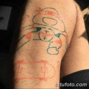 Фото тату: небрежный эскиз на руке, выполненный в сине-красных тонах, с неровными линиями и абстрактными формами.